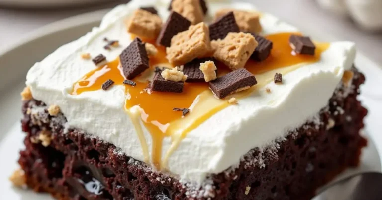 Best Ever Better Than Sex Cake Recipe (Easy, Moist & Over-the-Top! Slice of Better Than Sex Cake recipe topped with whipped cream, caramel drizzle, and crushed chocolate and toffee pieces on a plate with a spoon