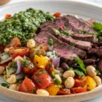 Sliced medium-rare flank steak with dense three-bean salad and fresh chimichurri sauce