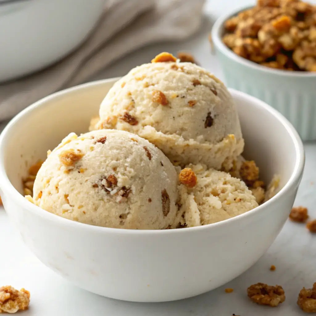 Creamy Jamaican Grape Nut Ice Cream in a white bowl, featuring crunchy Grape-Nuts cereal and a smooth egg-free vanilla base.