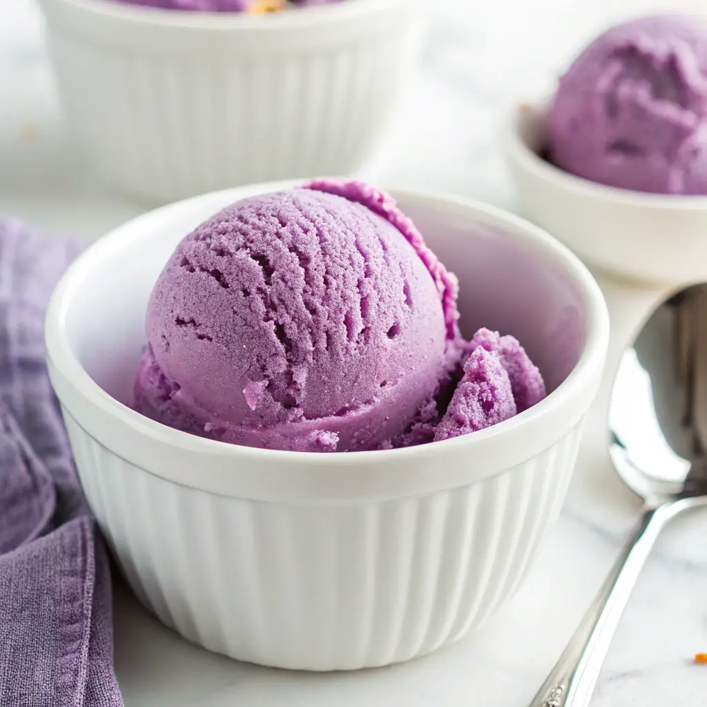 Close-up of Grapico Ice Cream in a bowl showing its deep purple color and creamy texture.