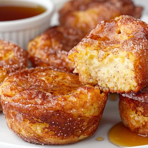 Cinnamon sugar French toast muffins with golden tops and a soft custardy center.