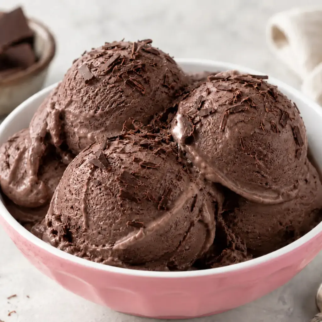 Chocolate Cottage Cheese Ice Cream scooped into a pink bowl with chocolate shavings, a creamy high-protein dessert for a recipe card.