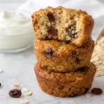 High protein Greek yogurt muffins made with oats, no flour and no protein powder, stacked with one split open showing the moist crumb